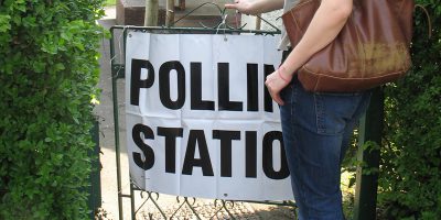 image of someone standing at the entrance of a polling station