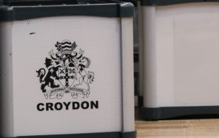 Metallic ballot boxes with Croydon council logo on one