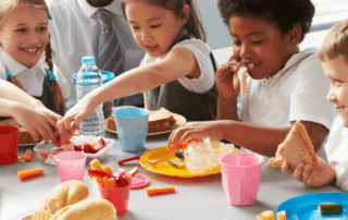 A group of children eating lunch.