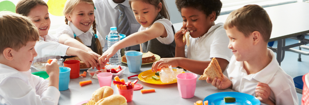 A group of children eating lunch.
