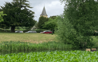 A view of Sanderstead Village with the pond in the front and the medieval church in the background.