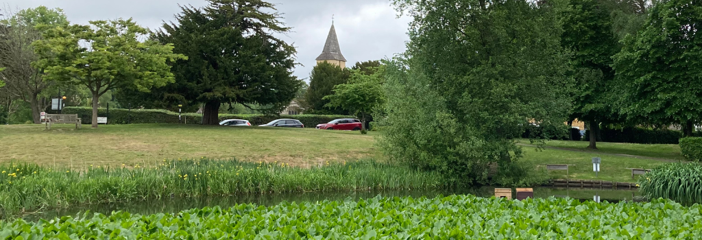 A view of Sanderstead Village with the pond in the front and the medieval church in the background.