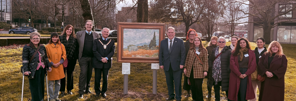 Mayor Perry, the Civic Mayor, the Director of the National Gallery and residents stand in Queen's Gardens in front of the Van Gogh's Sunflowers in the Art on Your Doorstep exhibition.