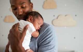A father cradling his baby