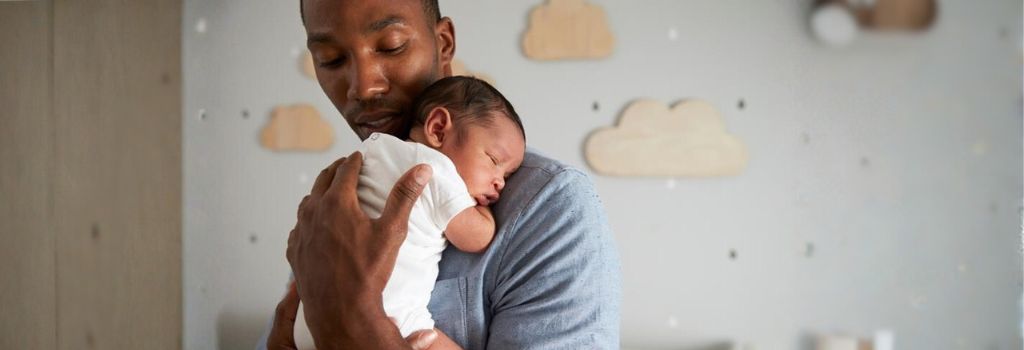 A father cradling his baby