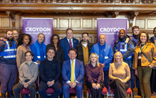 Group photo of representatives from Croydon BID, Executive Mayor Perry, and council staff, in Braithwaite Hall